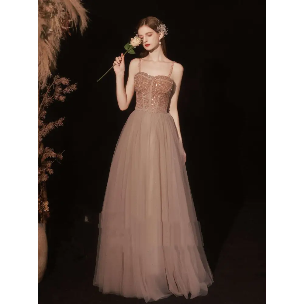 A champagne-colored golden suspender dress with rose gold sequin beaded bodice and layered tulle skirt for dress female dinner