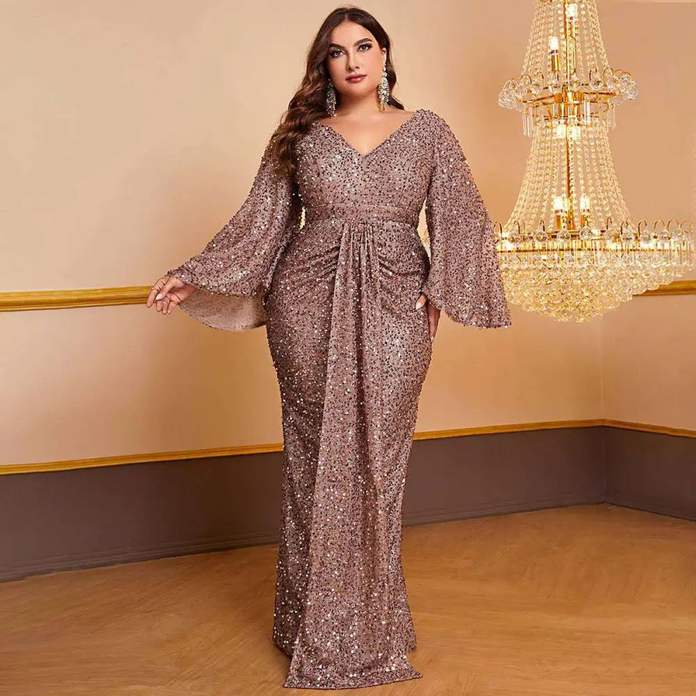 Rose gold sequin gown with v-neckline, bell sleeves, and long sleeved pleated design for elegant occasions