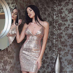 A shimmering rose gold strap sequin dress with a deep gold v neck and thin spaghetti straps bodycon style