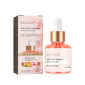 A pink glass bottle with gold dropper cap labeled eelhoe rose oil anti-aging facial firming rich serum for brightening