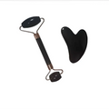 Black jade quartz facial roller with rose gold accents and matching gua sha wrinkle remover tool set