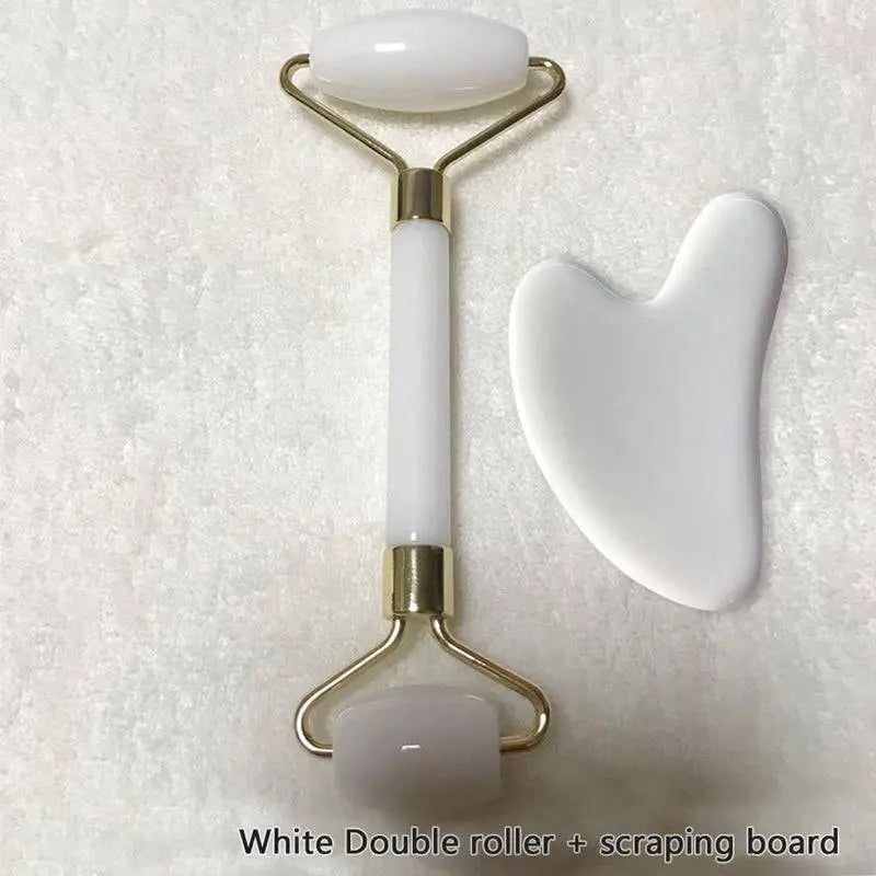 White double quartz facial roller with gold metal frame and matching white gua sha wrinkle scraping board