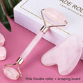Pink rose quartz facial roller and gua sha wrinkle remover with gold-toned accents and matching pink stone scraping board