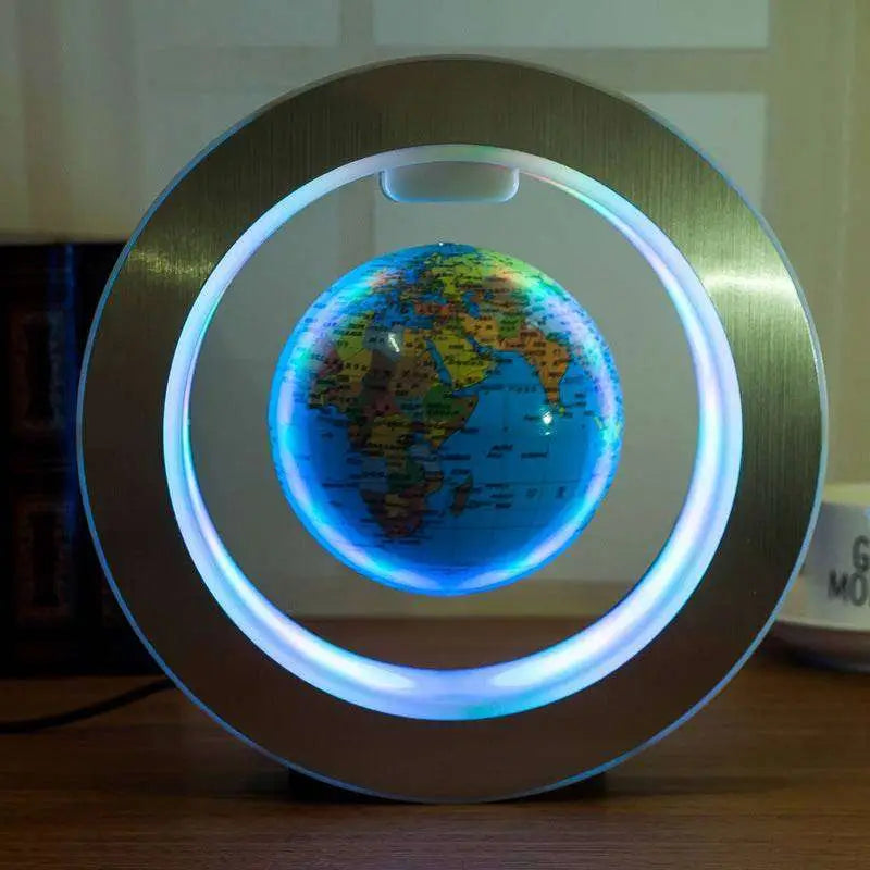 A round led world map floating globe light with a glowing blue led ring and brushed metallic frame suspended globe