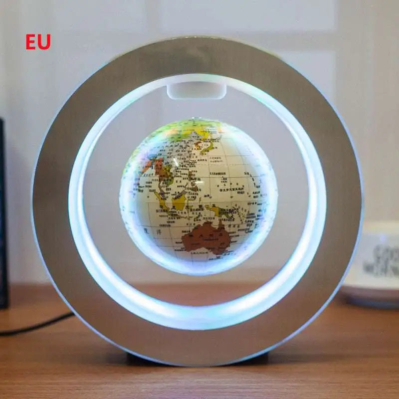 A glowing silver round led world map floating globe light with colorful landmasses levitating by magnetic suspension