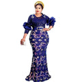 A navy blue round neck slim fit evening dress with floral embroidery and ruffled half sleeves cinched by a silver belt