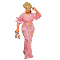 A woman wears a pink floral embroidery evening dress with round neck shirt design, slim fit, half sleeves, and gold belt