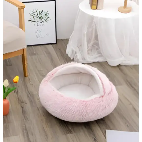 Pink round plush cat bed pet with soft faux fur exterior and cozy warm interior for comfortable resting