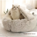 A cozy pink round plush cat bed pet made of warm faux fur with a soft, fluffy texture and snug design