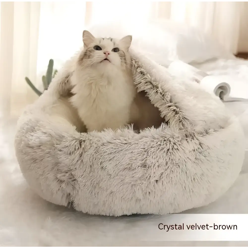A cozy pink round plush cat bed pet made of warm faux fur with a soft, fluffy texture and snug design