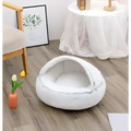 White fluffy cat bed pet with cozy rounded design made of soft faux fur pink round plush material
