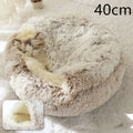 Pink round plush cat bed pet with a cozy faux fur beige and white exterior and soft inner lining for warmth