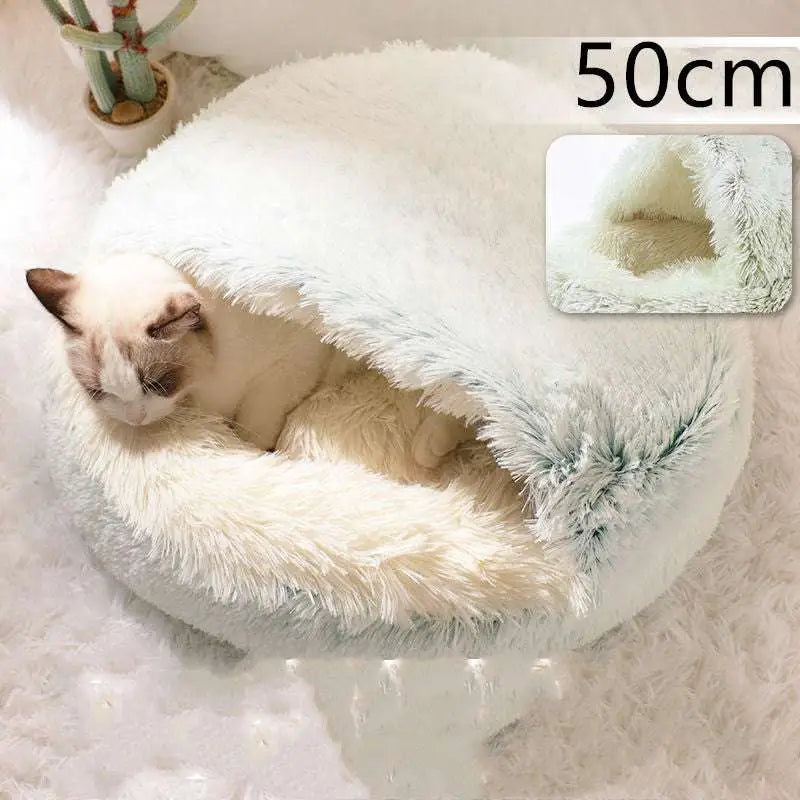 A pink round plush cat bed pet with cozy white faux fur and a soft, snug, rounded design for warmth and comfort
