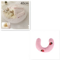 Pink round plush cat bed pet with strawberry appliqués made of warm faux fur for cozy comfort