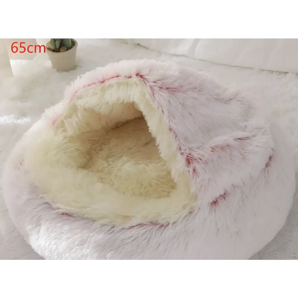 Pink round plush cat bed pet with fluffy white and cream faux fur and soft fuzzy texture for warmth and comfort