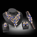 Elegant royal blue bridal accessories necklace earrings set featuring blue and white crystals with gold-tone metal accents