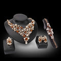 Gold-toned bridal clothing accessories necklace earrings with amber and white pearls for royal blue bridal wear displayed on busts