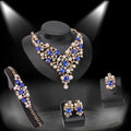 Elegant gold-toned royal blue bridal clothing accessories necklace earrings set with crystals, pearls, and rhinestones