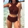 A stylish brown two-piece swimsuit with a draped cross halterneck pleated top and high-waisted bottoms