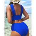 Vibrant royal blue cross halterneck pleated swimsuit with high-waisted bottoms and a backless wide strap top