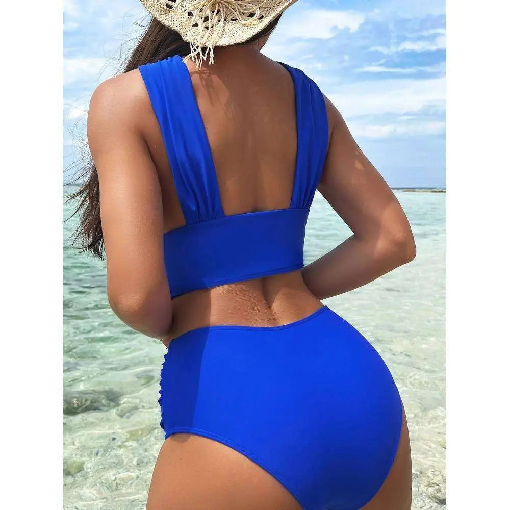 Vibrant royal blue cross halterneck pleated swimsuit with high-waisted bottoms and a backless wide strap top