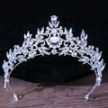 Silver royal blue gold rhinestone mitzvah crown with intricate leaf floral designs and central large faceted gemstone