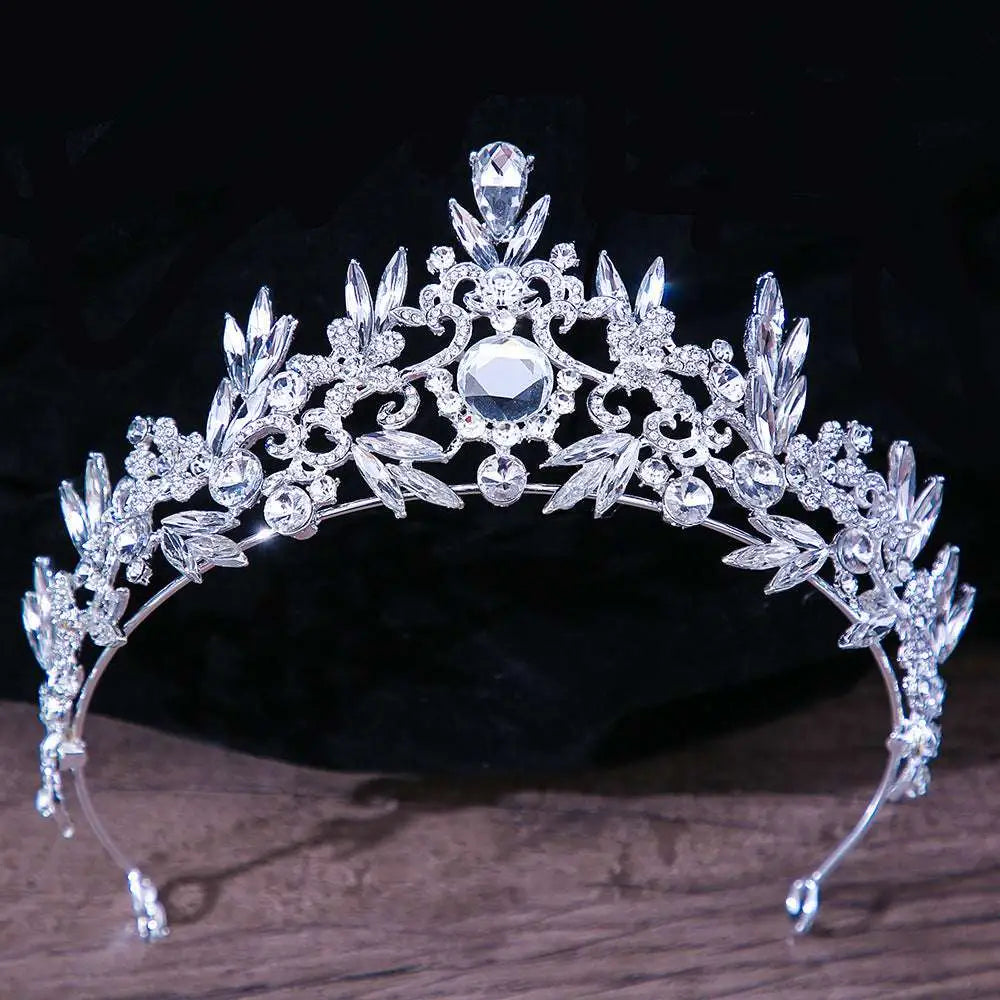 Silver royal blue gold rhinestone mitzvah crown with intricate leaf floral designs and central large faceted gemstone