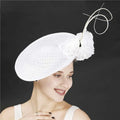 Royal blue headdress bride beige hat in imitation linen featuring a white woven fascinator with floral and wire accents