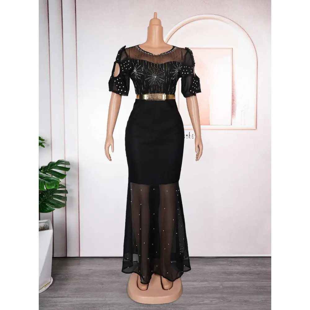 Black mermaid-style dress with sheer beaded bodice and skirt featuring embroidered hot diamond beads gown details
