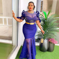 A woman wears a royal blue heavy embroidered hot diamond beads gown with sheer beaded bodice and mermaid skirt