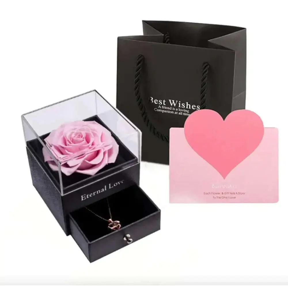 Pink preserved rose in a clear acrylic display box with black base and drawer for royal blue preserved rose jewelry gift