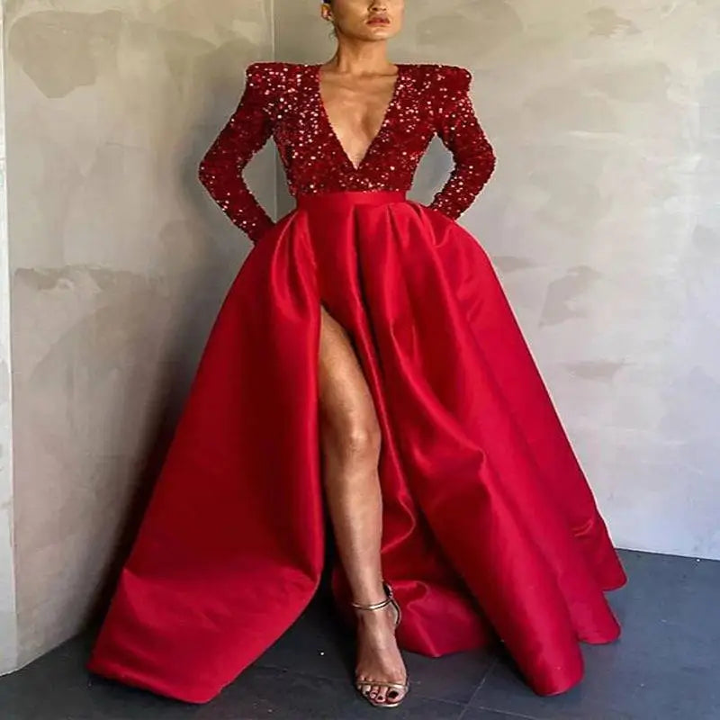 A striking red evening dress with a sequined bodice, satin skirt, long sleeves, and a high slit