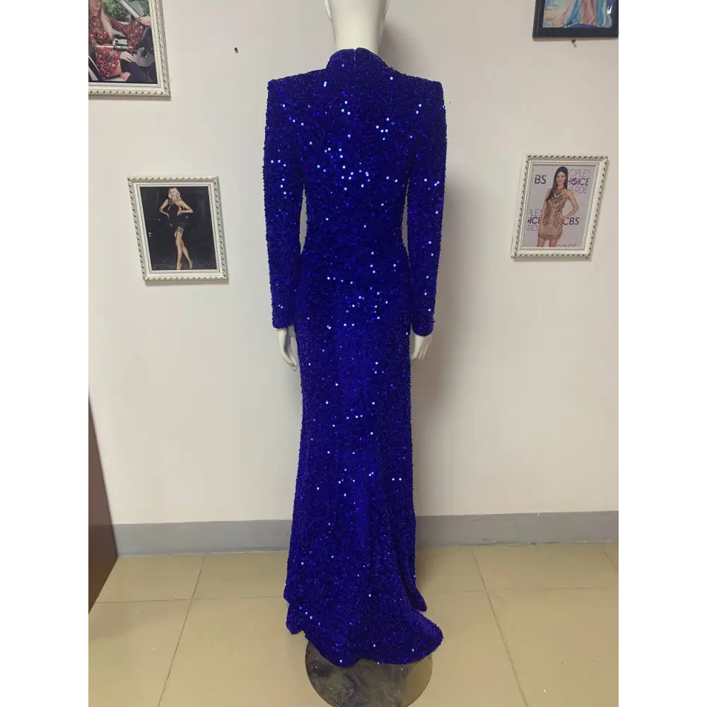 A royal blue siren long sleeve gown with a high neckline featuring siren ji sequin high slit design on a mannequin