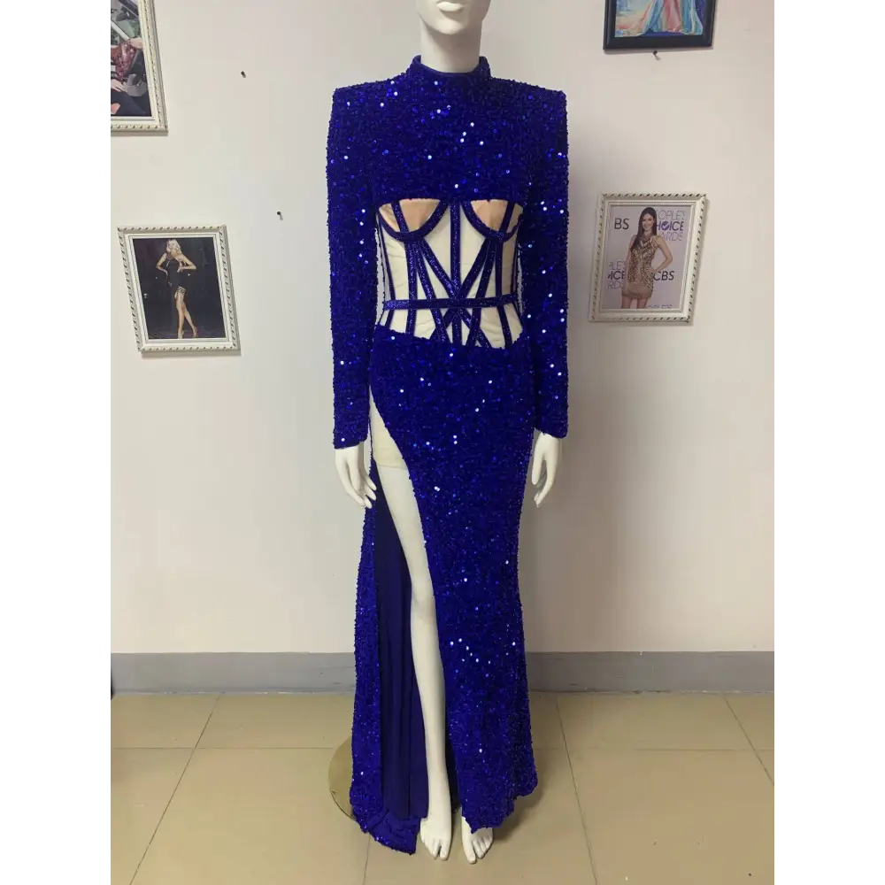 A royal blue siren ji sequin high slit dress with long sleeves, high neckline, and dramatic thigh-high slit