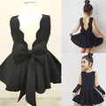 Black sleeveless princess dress with scalloped neckline and large bow at the back for royal blue summer girls wear