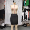 Ruched black high waist tight pu leather mini skirt displayed on a mannequin in front view