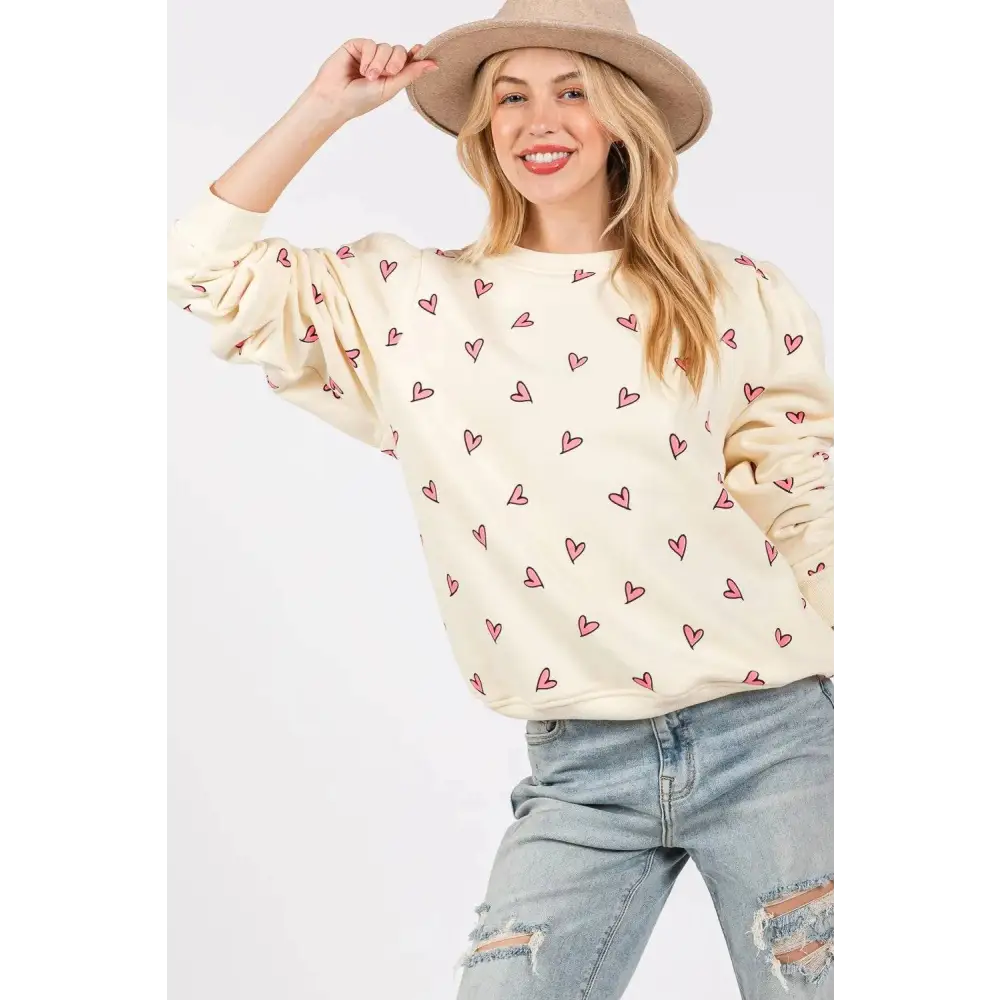 Cream-colored sage fig long sleeve sweatshirt featuring a playful fig heart printed pattern with small pink hearts
