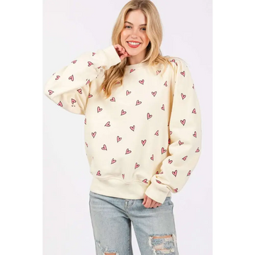 Cream-colored sage fig fig heart printed long sleeve sweatshirt featuring a playful pattern of small pink hearts