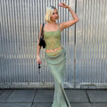 A sage green lace backless tube crop top with sheer floral design stitching ruffle hip detail and thin straps
