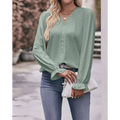 A light green blouse with lace sleeves fashionable design featuring eyelet pattern and ruffled cuffs, versatile shirt