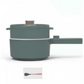 A sleek sage green matte electric cooking pot with two tiers and a matching lid featuring a copper-toned knob