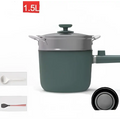 Sage green matte electric cooking pot with matching lid and silver handle featuring dual-layer and steam rack