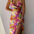 A vibrant pink yellow and blue tie-dye satin slit sling dress with flowing fabric ideal for sling dress summer fashion