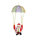 Santa claus climbing rainbow parachute toy with red white suit black shoes holding colorful sheer fabric ropes