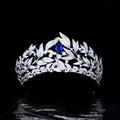 A sparkling silver tiara with copper micro inlay featuring a sapphire crown and intricate leaf and vine motifs