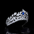 A sparkling silver tiara with copper micro inlay featuring a sapphire crown and intricate leaf and vine motifs