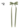 A delicate sage green satin bow braided hair ribbon tie set with long flowing tails for hair tie double styling