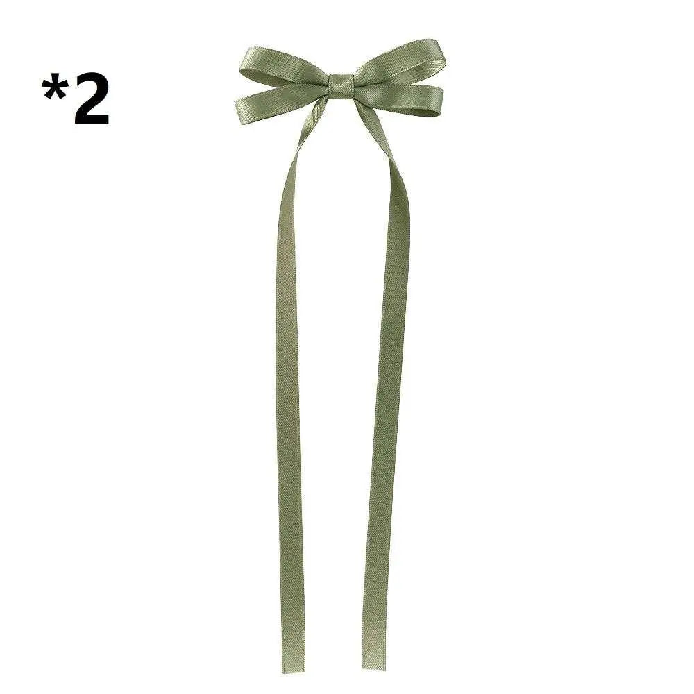 A delicate sage green satin bow braided hair ribbon tie set with long flowing tails for hair tie double styling