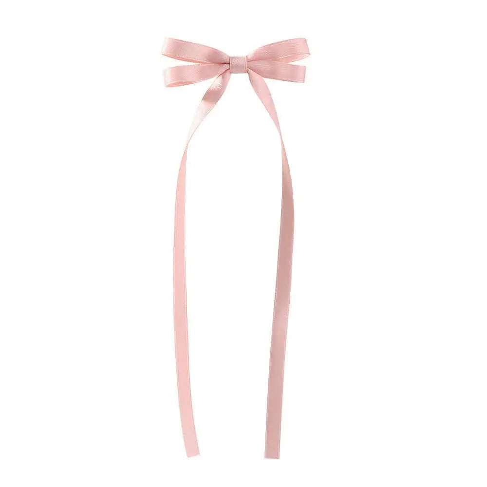 A delicate pink satin bow braided hair ribbon tie set with long flowing tails as a hair tie double accessory