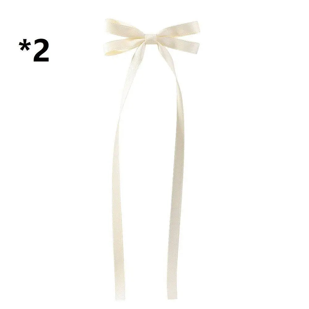 Cream-colored satin bow braided hair ribbon tie set with long flowing tails for elegant hair styling hair tie double